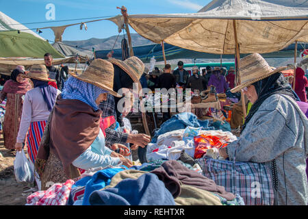 Oued Laou, Chefchaouen, Morocco - November 3, 2018: Women dressed in the traditional attire of the area doing their shopping in the market Stock Photo