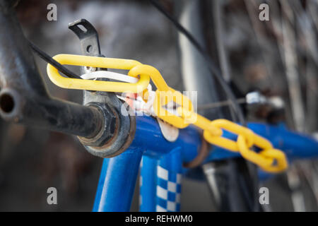plastic yellow chain on bicycle in winter Stock Photo