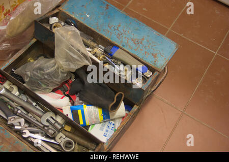 Photograph from above of a toolbox that is on the floor and belongs to a plumber who does home work related to plumbing Stock Photo