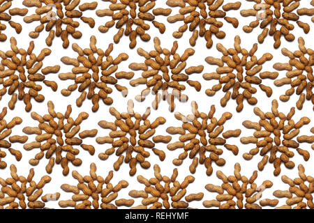 Pattern of Nuts - unpeeled peanuts on a white background in the shape of a circle. Concepts about decoration, healthy eating and food background. Stock Photo