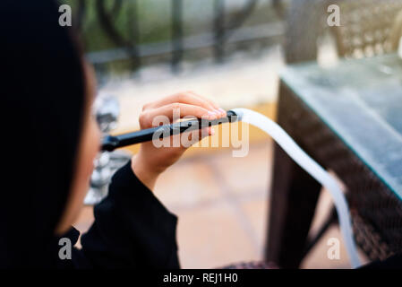 Muslim woman smoking hookah in a coffee bar Stock Photo