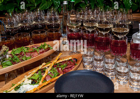 Various snacks and alcohol in glasses on a celebratory table for a buffet table. Stock Photo