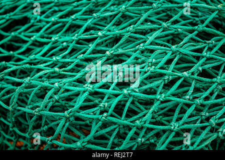 Close-up of Fishing Trawler Nets stacked on harbour quayside Stock Photo