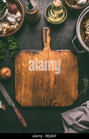 Empty cutting board food background. Rustic  table with ingredients and kitchen utensils . Cooking concept. Top view. Frame Stock Photo