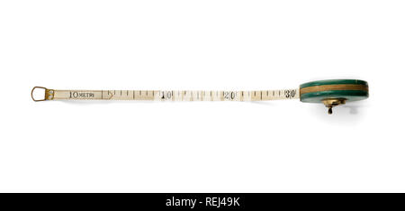Retractable ribbon measuring tape marked in centimeters with a winding roll-up mechanism viewed partially extended over white from above Stock Photo