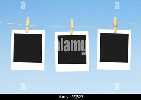 Three blank polaroid photos against blue sky Stock Photo