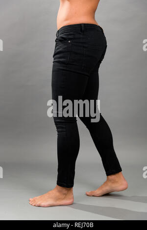 Modern male unbranded Black skinny jeans isloated on grey background Stock Photo