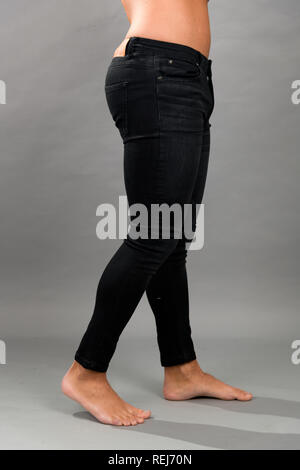Modern male unbranded Black skinny jeans isloated on grey background Stock Photo