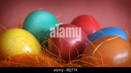 Painted Easter Eggs on orange straw Stock Photo
