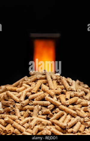 Wood pellets with combustion chamber in the background. Stock Photo