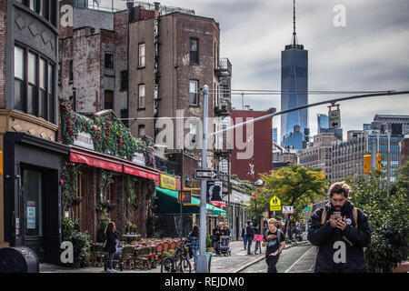 Greenwich Village, New York, USA October 16 2018. A view of One World Trade Center from Greenwich village with pedestrians walking the streets past re Stock Photo