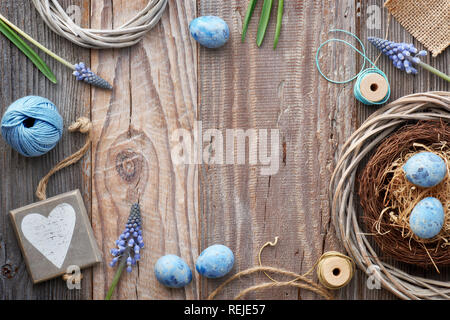 Easter background with blue hyacinth flowers, Easter eggs, wooden heart and decorations on rustic wood with copy-space Stock Photo