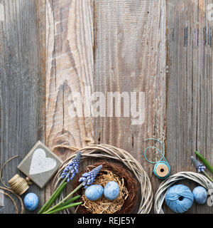Easter background with eggs, blue hyacinth flowers and  wooden heart, top view on rustic wood, square composition with plenty of copy-space Stock Photo