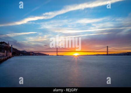 sunset at 25 de Abril Bridge in lisbon, portugal Stock Photo