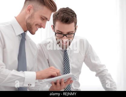 close up.two employees looking at the digital tablet screen Stock Photo