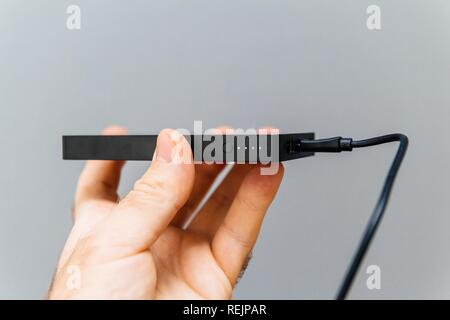 Checking charge on the power bank for charging mobile devices also know as external battery for mobile devices such as smartphones, tablets and wearable devices Stock Photo