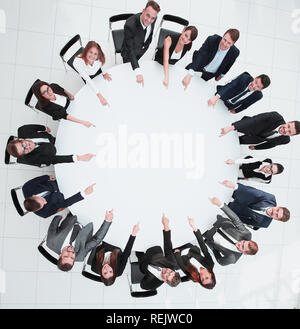 closeup .business team pointing in the center of the table. Stock Photo