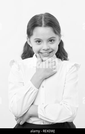 She is planning a prank. Girl school uniform smiling cunning face yellow background. Girl happy back to school. Child ready back to school end continue fun. Schoolgirl formal outfit looks cute. Stock Photo