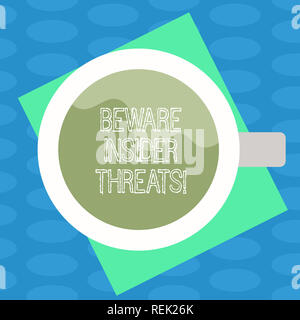 Word writing text Beware Insider Threats. Business concept for Be cautious on malicious attack inside the network Top View of Drinking Cup Filled with Stock Photo