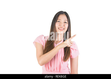 Smiling asian young woman in pink dress with finger point to the side. Stock Photo