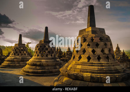 Stupas on the top of the Borobudur temple on a cloudy evening Stock Photo