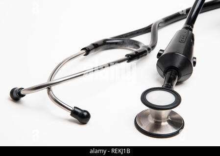 A medical doctor's electronic stethoscope set on a plain white background in horizontal format. Stock Photo