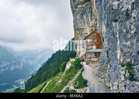 Wooden house on rock. Berggasthaus Aescher-Wildkirchli, Ebenalp, Appenzell,  Switzerland Stock Photo