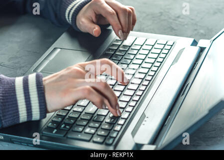 Hacker the programmer is typing on the keyboard of the laptop to hack the system. Stealing personal data. Creation and infection of malicious virus. Stock Photo