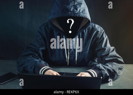 Anonymous hacker programmer uses a laptop to hack the system. Stealing personal data. Creation and infection of malicious virus. The concept of cyber  Stock Photo