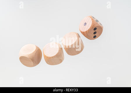 Business & design concept - Abstract geometric real floating wooden dice isolated on background, it's not 3D render. symbol of leadership, teamwork an