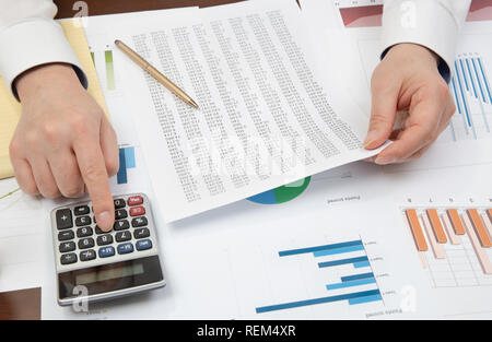 Workplace businessman. Contracts, charts, and graphs on the desk. Stock Photo