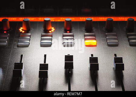 Faders of a modern mixing console, music studio equipment details. Stock Photo