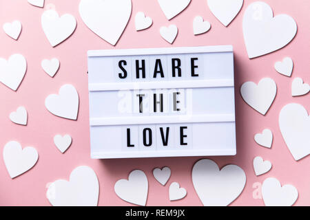 Share the Love lightbox message with white hearts on a pink background Stock Photo