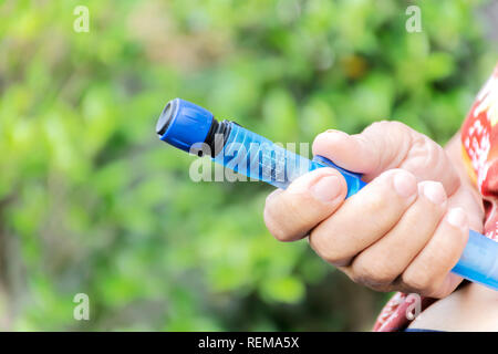 Close up of old female diabetes patient making subcutaneous insulin injection into her abdomen with insulin pen syringe at home. Diabetes, health care Stock Photo