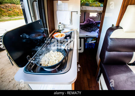 Cooking dinner or lunch in campervan, motorhome or RV. Preparing
