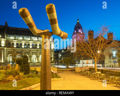 Leeds Town Hall from the Both Arms sculptureby Kenneth Armitage in Mandela Gardens at Dusk Leeds West Yorkshire England Stock Photo