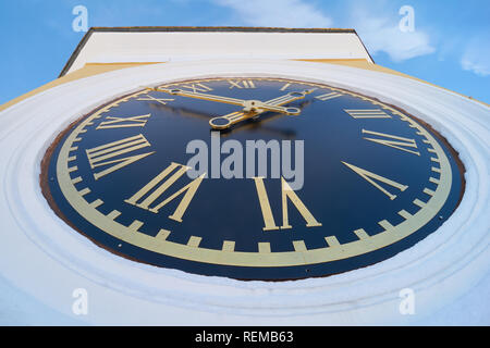 Turret clock with roman numerals on blue clock face. Bell tower of the Epiphany Cathedral in the Monastery of Nilo-Stolobenskaya Pustyn, Tver oblast,  Stock Photo