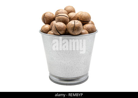 Macadamia nuts in a tin bucket on white background. With clipping path. Stock Photo