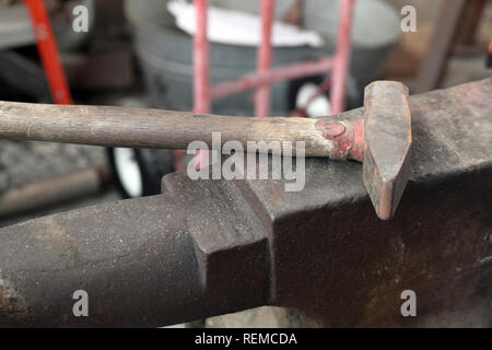 Blacksmith tools anvil and hammer in workshop Stock Photo