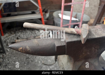 Blacksmith tools anvil and hammer in workshop Stock Photo
