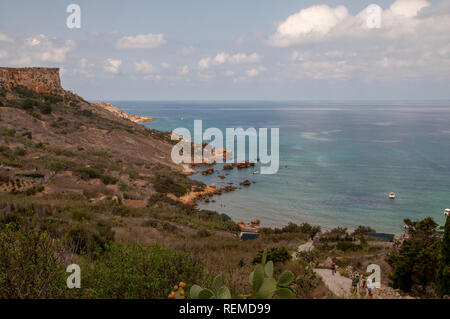 Looking over quiet San Blas Bay and its beach with red sand on Gozo, Malta. Stock Photo