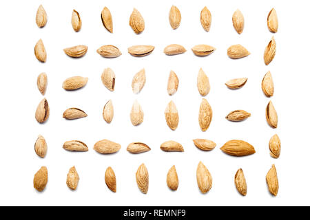 A collection of peeled almonds Badam lie in horizontal rows on an isolated white background. with clipping path. Peeled almonds Badam pattern Stock Photo