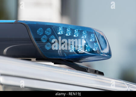 Detail shot of a blue light on a police car on the street Stock Photo