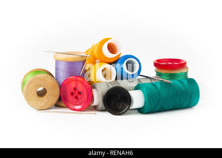 Multi-colored threads on spools and reels. Needles and buttons. On a white background. Stock Photo