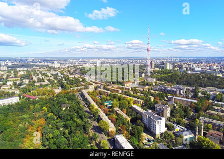 Aerial view of Kiev city streets with park and high steel TV tower against blue sky om bright sunny day Stock Photo
