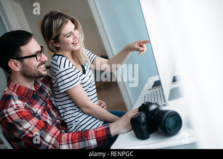 Young attractive designers working on project together Stock Photo