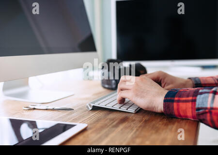 Close-up picture of man working on computer Stock Photo