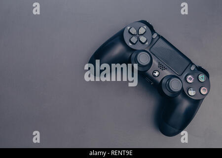 LONDON - JANUARY 15, 2019: Video games PlayStation gaming controller on dark black background Stock Photo