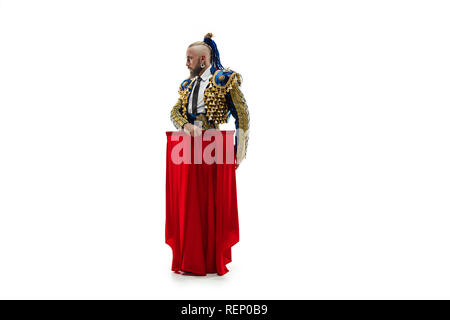 Torero in blue and gold suit or typical spanish bullfighter isolated over white studio background. The taming, achieving the goal, mortification, conquest, boss, leadership, battle, win, winner concept Stock Photo