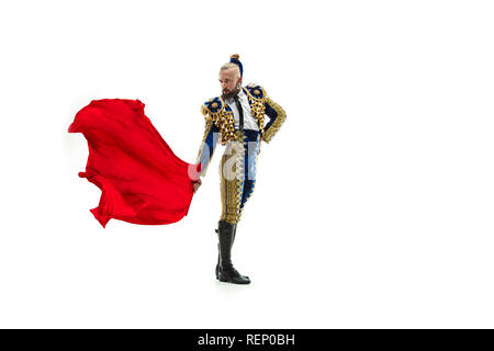 Torero in blue and gold suit or typical spanish bullfighter isolated over white studio background. The taming, achieving the goal, mortification, conquest, boss, leadership, battle, win, winner concept Stock Photo